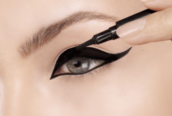 very bold liquid eyeliner being applied around blue eye