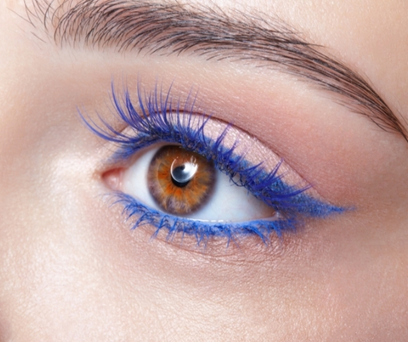 Close-up of creative blue eyeliner and soft pink eyeshadow, offering bold and modern bride makeup ideas for a unique wedding look.