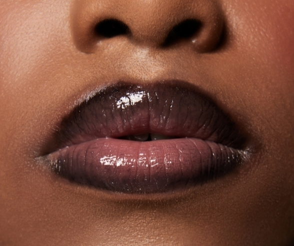 Close-up of glossy nude lips with soft ombré shading, capturing a chic and modern bold bridal makeup look for contemporary brides.