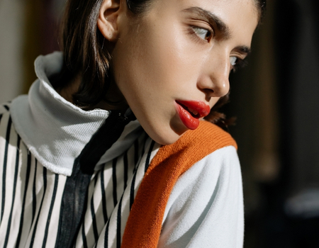 High-fashion makeup look highlighting bold red lips