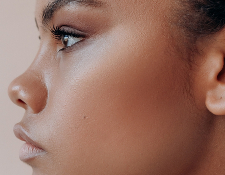 Natural makeup look highlighting skin texture and subtle contour”