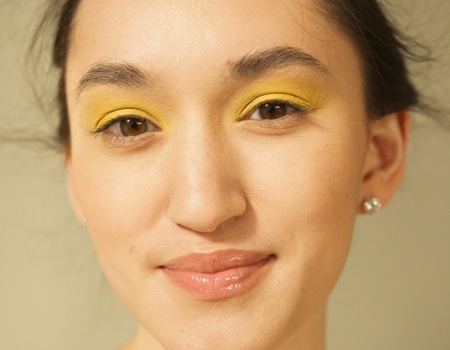 Yellow eyeshadow makeup look with fresh, natural skin finish