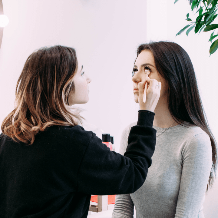 makeup artist applying makeup on client during consultation