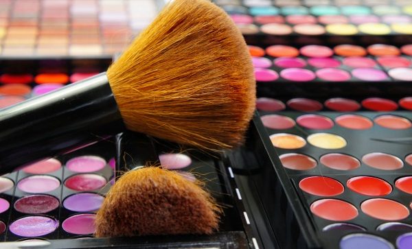 Makeup brushes on bright palettes