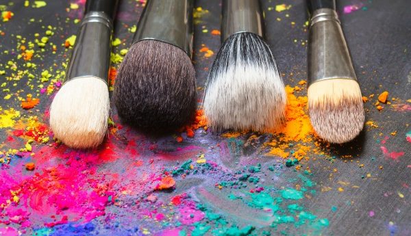 Makeup brushes and bright powder makeup