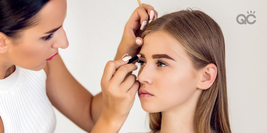 makeup artist applying brow makeup