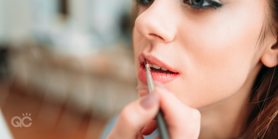 applying lipstick with a lip brush makeup artist kit