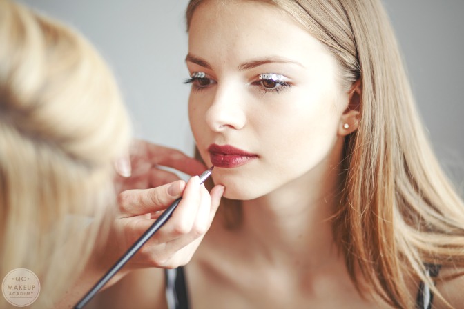 Master makeup artist applying makeup on set