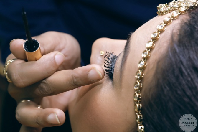 Applying makeup to South Asian brides
