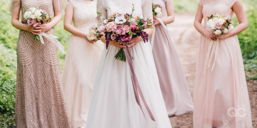 bridesmaids and bride in blush pink dresses as styled by a fashion stylist