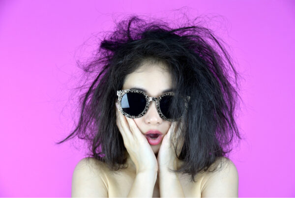 millennial trends that need to die - frazzled girl with messy hair and sunglasses on
