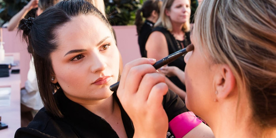 Makeup by Birri-Li applying makeup at a professional makeup tradeshow