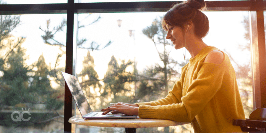 female student writing on laptop