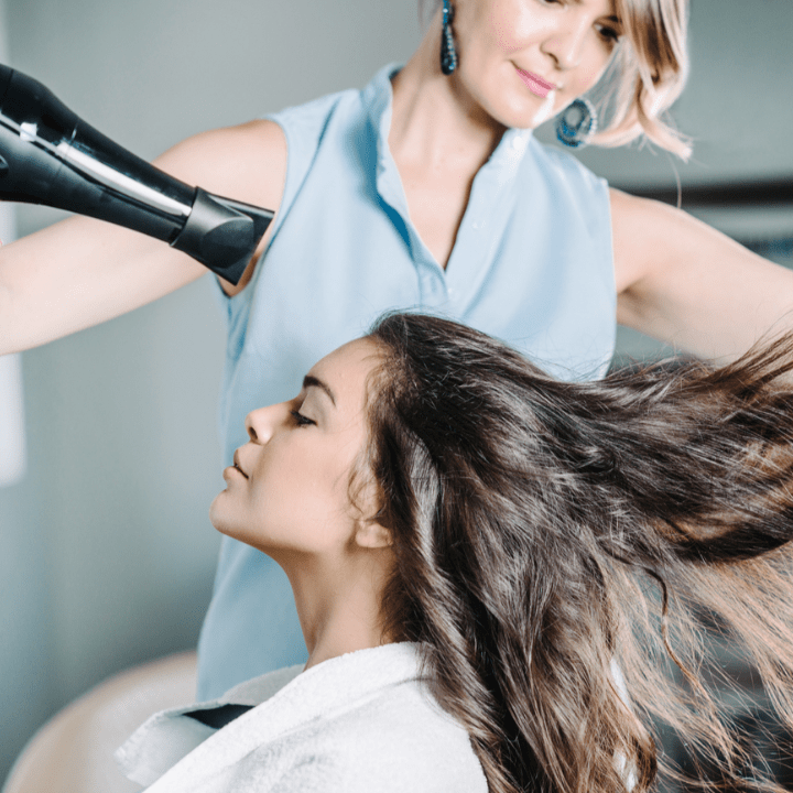hair styist blow drying client's hair