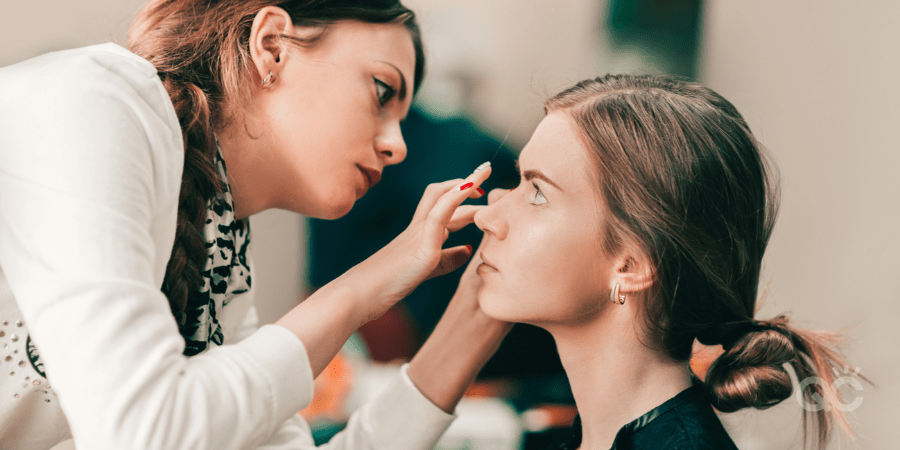 professional female mua applying client's makeup