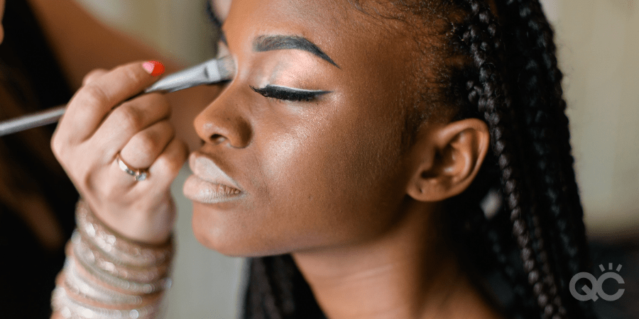 makeup artist training on model
