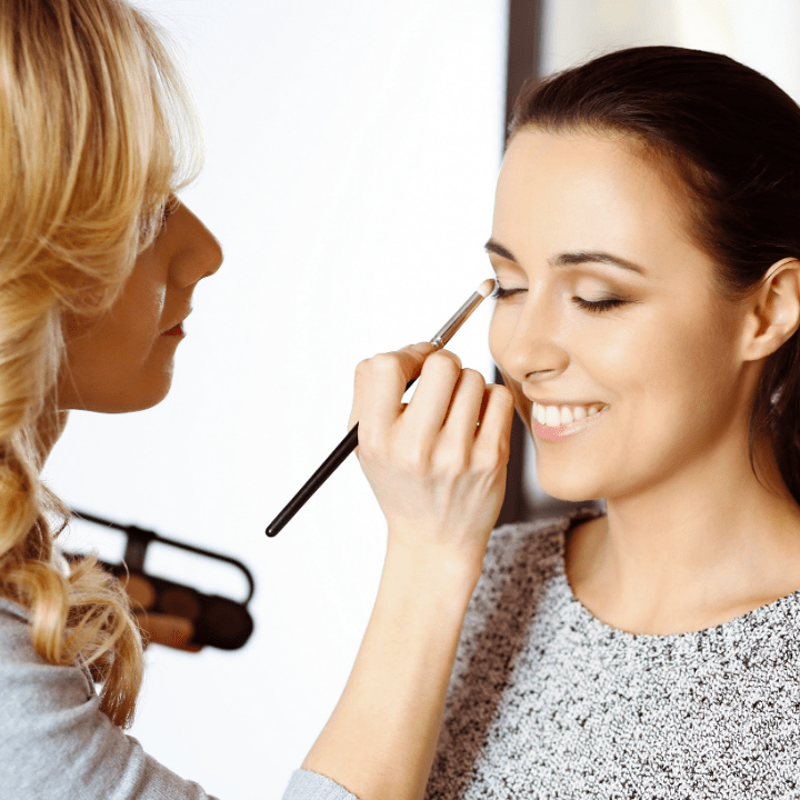 makeup artist working on client