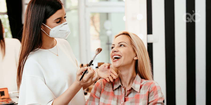 makeup artist wearing mask and working on female client