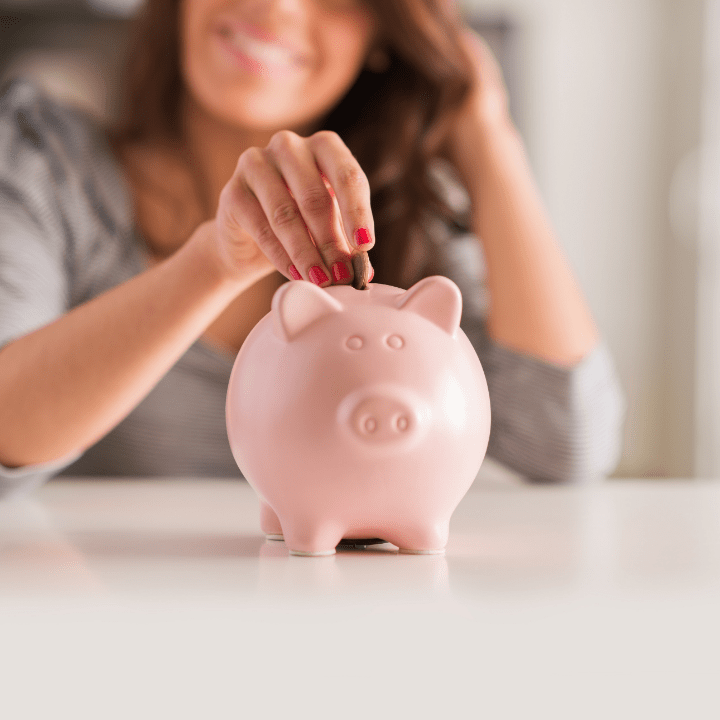 woman increasing makeup artist salary, putting money into piggy bank
