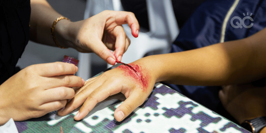 special effects makeup artist creating wound effect on client's hand
