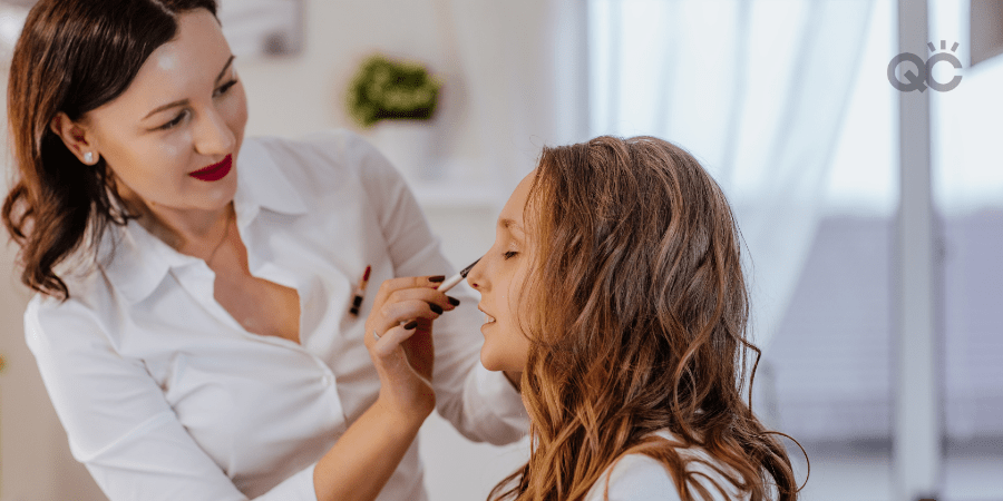 makeup artist applying makeup on client's face