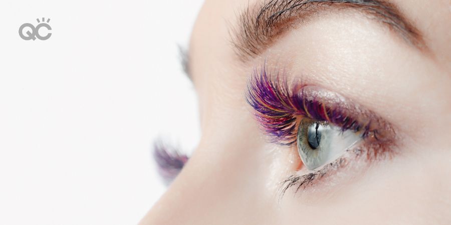 Beautiful woman on color eyelash extension procedure in spa salon. Concept fashion