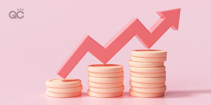 Red up arrow and coin stacks on pink background. Financial success and growth concept