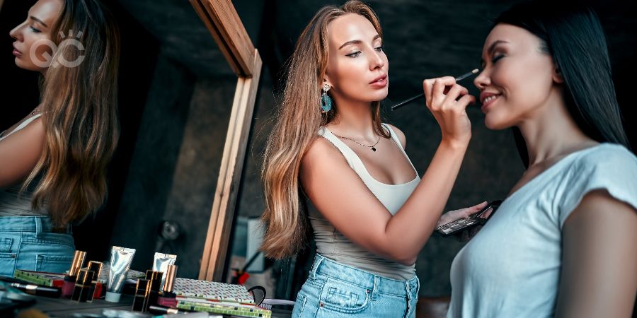 Makeup artist in beauty studio working with beautiful asian makeup model