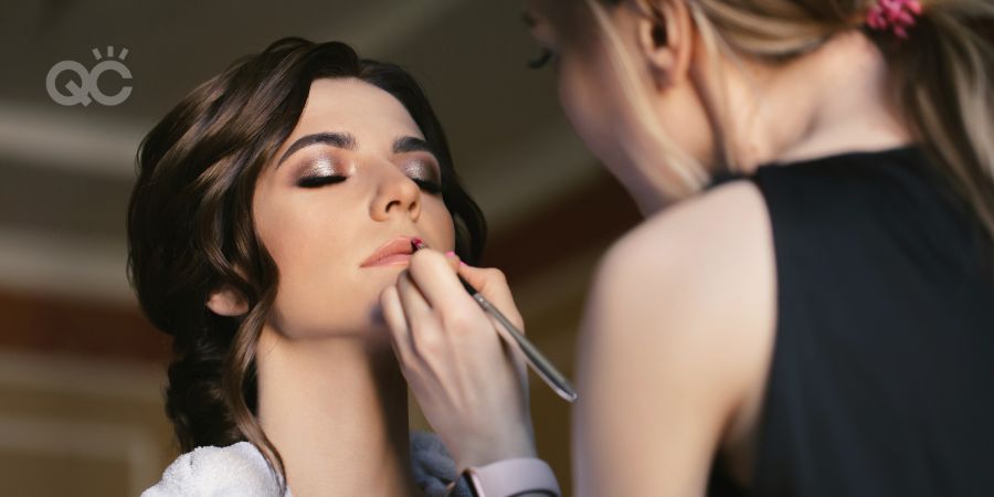 Makeup artist doing make up for young beautiful bride.