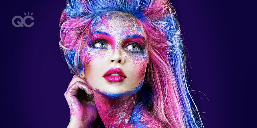 close up portrait of young beautiful girl with colorful face painting. Halloween professional makeup. hair in paint. beauty portrait. blue and pink hair