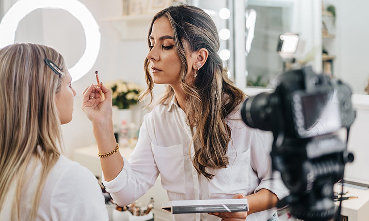 Makeup Artist applying makeup to client